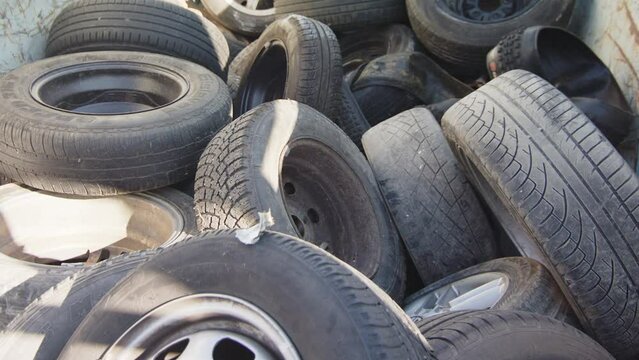 Closeup shot of end of life discarded car tyres lying on pile at tyre graveyard