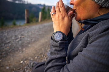 Girl with Fitness Smartwatch Drinking Tea on a Hike
