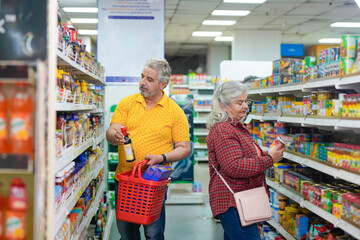 Senior indian couple purchasing together at grocery shop