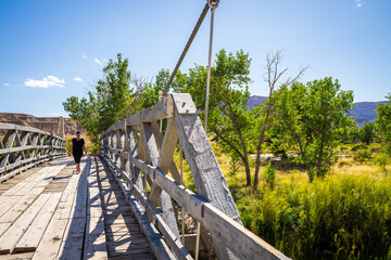 Woman walking across a Bridge in San Rafael Swell