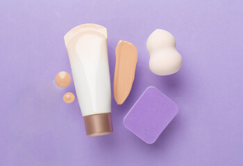 Composition with makeup foundation on color background, top view