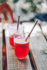 Bright fresh coctails on the wooden table in the summer. Sweet taste of the vacation. 