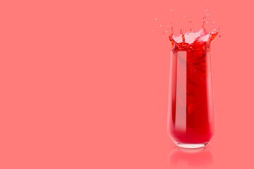 Cherry fresh red juice in glass with reflection, drops and splashind on pastel pink background, copy space. Vitamin organic summer drink with splashes, drops and motion in glass.