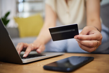 Hands, credit card and ecommerce on laptop in home for digital payment, fintech password and online shopping. Closeup of person, computer and customer banking for financial bills, budget and account