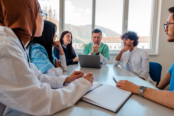 A medical team of doctors discussing at a meeting in the conference room.