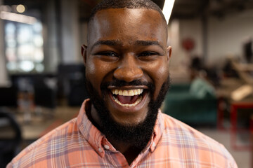 Portrait of a african american businessman smiling at modern office