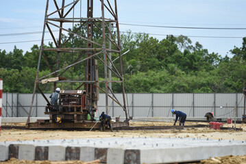 Fototapeta na wymiar concrete pole with derrick on duty in construction site