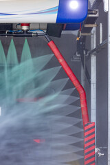 action. Car going through an automated wash. High-pressure water spray in the wash machine. Dotted with soap suds. Tunnel Wash Automatic Car.