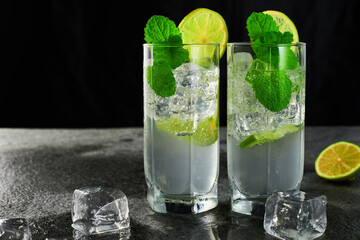 Two glasses of refreshing mojito cocktail with ice cubes. Low angle studio shot.