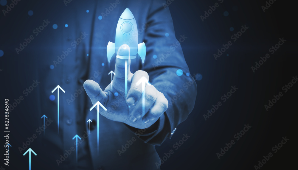 Poster Close up of businessman hand pointing at glowing flying blue rocket on dark background with mock up place. Start up and launch concept.