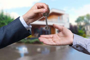 Fototapeta premium Home buyers are taking home keys from sellers. Sell your house, rent house and buy ideas.