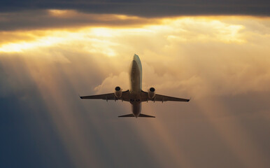 Fototapeta na wymiar Airplane in the sky at amazing sunset