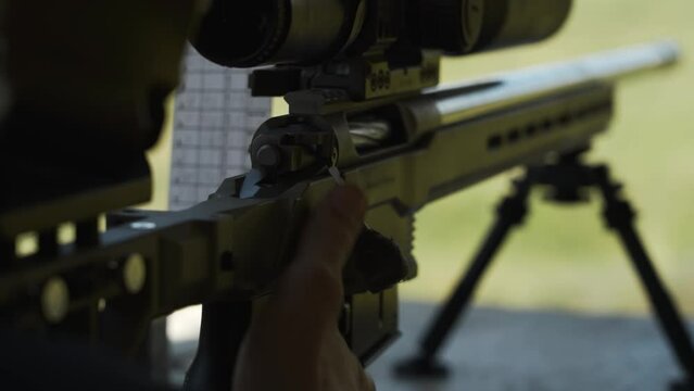 Insert a clip with cartridges and reloads a sniper rifle with an optical sight.