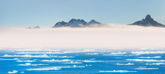 Melting icebergs by the coast of Greenland, on a beautiful summer day - Melting of a iceberg and pouring water into the sea - Greenland