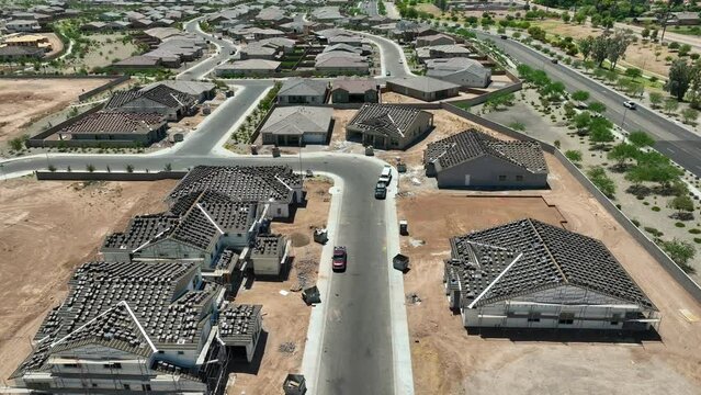 Southwest USA houses ready for roof. Aerial descending shot of homes in neighborhood with shingles on roof waiting for installation. Housing under construction. Population boom.