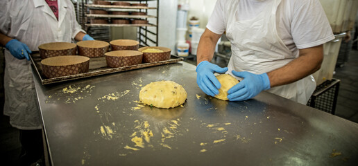 Workers work in the production line of an industry of bread, cakes and panettones in Sicily.