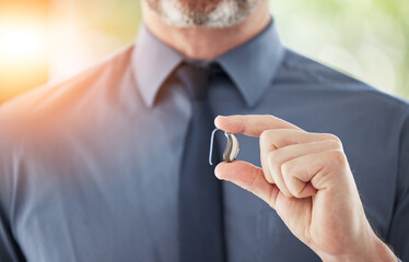 Hearing aid, hands and business man with disability for communication support, listening and...