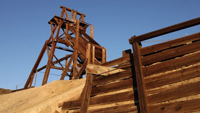 Camera Tilts Down on Abandoned Mine Headframe in the Desert - Shallow Depth of Field
