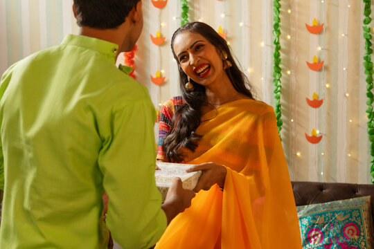 Friends exchanging gift on the occasion of Diwali