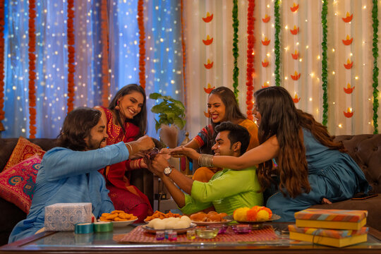 Friends playing cards together at home on the occasion of Diwali
