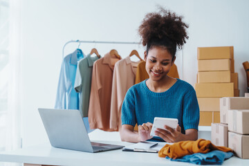 Fototapeta premium Sell Clothes Online With Print-On-Demand, pretty african american clothing designer selling online start a sustainable fashion brand High-quality print on demand clothing. Fast shipping worldwide.