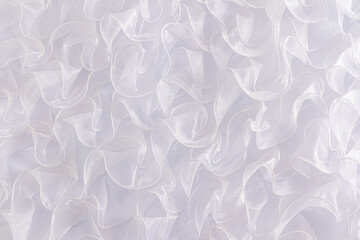 Snow-white wedding background for design or decor. Beautiful ruffles parts of the bride's wedding dress made of silk fabric. A copy space. layout.