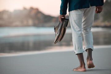 Walking, beach and feet of business man for journey on holiday, vacation and freedom by ocean. Professional, travel and male entrepreneur with shoes for calm, peace and relax in nature at sunset