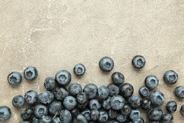 Colorful blueberries on grey concrete background. Top view. Flat lay