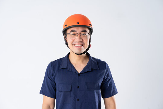 man wearing orange helmet on white background
