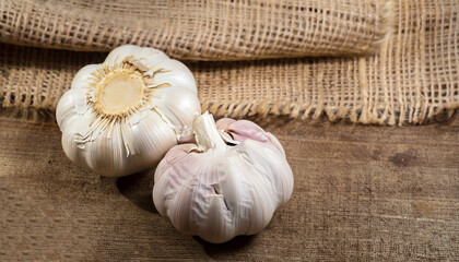 Garlic Over wooden and gunny sack background