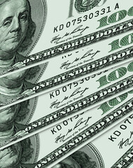 One hundred US dollar bills spread out like a fan in perspective