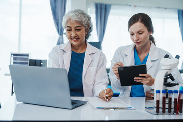 Health care researchers working in life science laboratory, Teaching in labs - Requiring students to record their laboratory methods and results as a running record of their laboratory work.