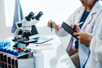 Health care researchers working in life science laboratory, Teaching in labs - Requiring students to record their laboratory methods and results as a running record of their laboratory work.