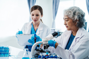 Fototapeta premium Health care researchers working in life science laboratory, Teaching in labs - Requiring students to record their laboratory methods and results as a running record of their laboratory work.