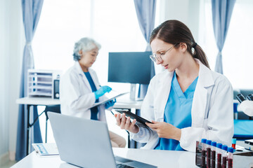 Health care researchers working in life science laboratory, Teaching in labs - Requiring students to record their laboratory methods and results as a running record of their laboratory work.