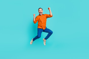 Fototapeta na wymiar Full size body photo of crazy businessman jumper winner success achievement fists up triumphant isolated on aquamarine color background