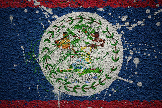 painted big national flag of belize on a massive old cracked wall