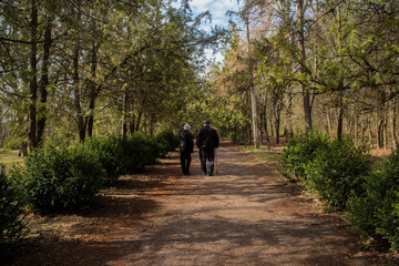 two retired people take a walk in the park.