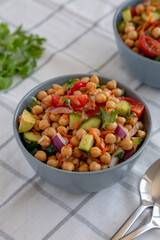 Homemade Avocado Chickpea Salad with Chili Lime Dressing in a Bowl, side view.