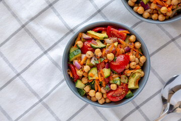 Homemade Avocado Chickpea Salad with Chili Lime Dressing in a Bowl, top view. Copy space.