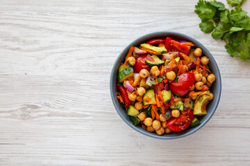 Homemade Avocado Chickpea Salad with Chili Lime Dressing in a Bowl, top view. Copy space.