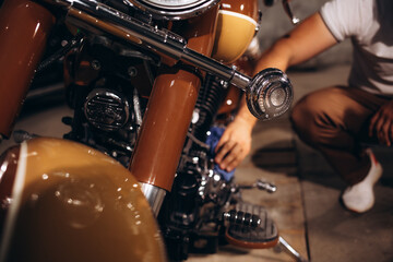 a man wipes his retro motorcycle