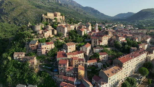 Aerial view of Corte old town, Corsica island. Morning shot of old houses on the mountain in Corte village, Corsica, France