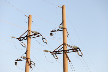 high-voltage pylons against the blue sky