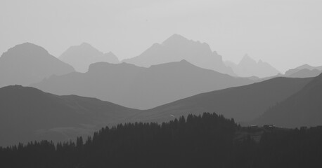 Monochrome image of mountain ranges in the morning light seen from Vorder Walig, Switzerland.