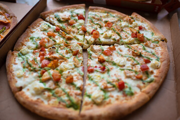 freshly baked pizza with cheese and sauce in a box. pizza delivery, received order in a box.