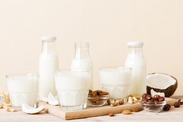 Set or collection of various vegan milk almond, coconut, cashew, on table background. Vegan plant based milk and ingredients, top view