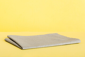 top view with gray kitchen napkin isolated on table background. Folded cloth for mockup with copy space, Flat lay. Minimal style