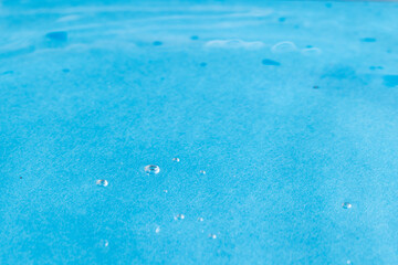 Close up of air bubbles, water ripples and waves with copy space on blue background