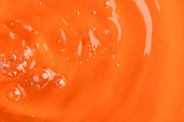 Close up of air bubbles, water ripples and waves with copy space on orange background
